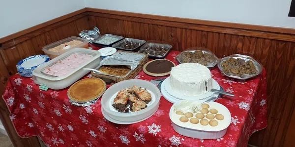 Dessert table with cakes, pies, and treats