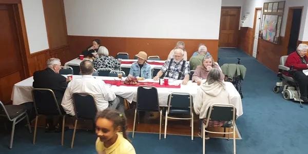 Church members fellowshipping at the lunch gathering