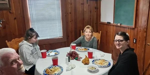 A family seated together enjoying the New Members' Lunch
